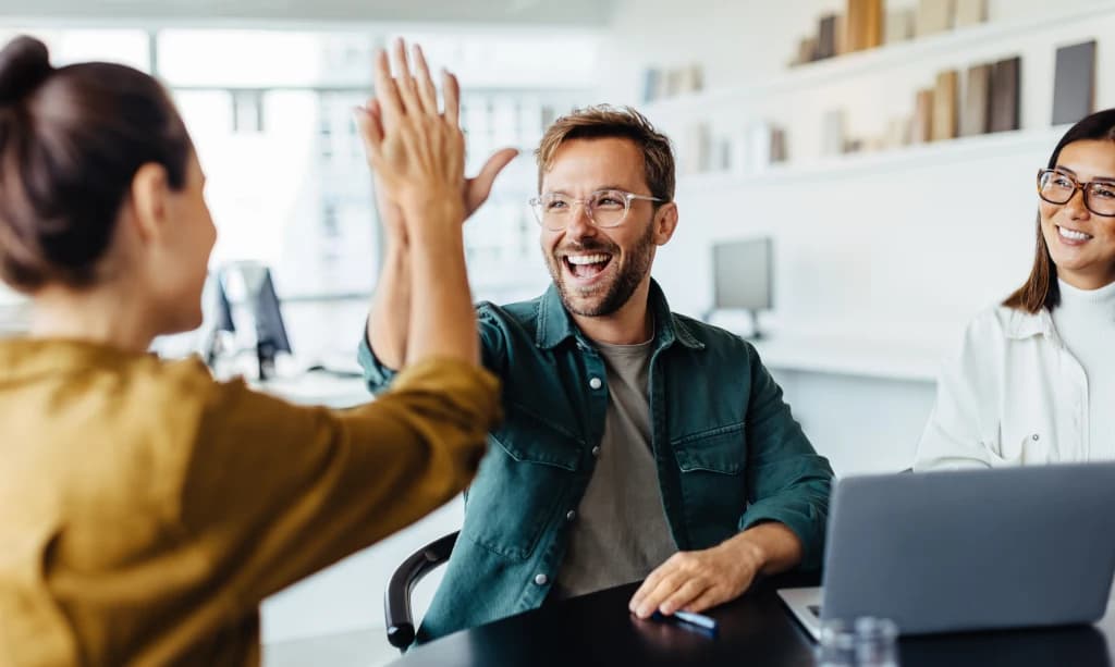Happy immigration consultants and clients working together